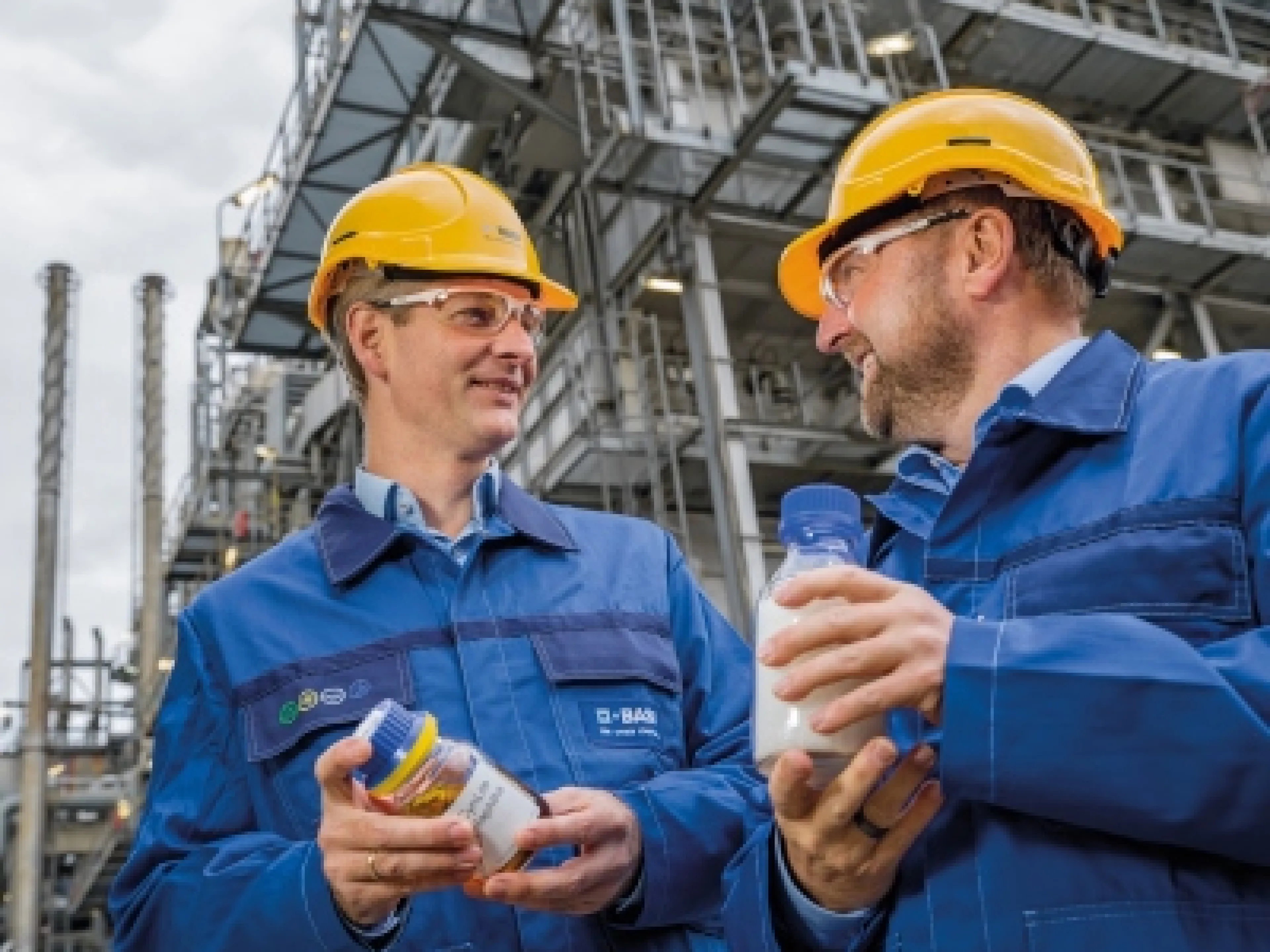 Dr. Stefan Gräter und Dr. Andreas Kicherer zeigen eine Probe von Pyrolyseöl und damit hergestellten Kunststoff vor dem Steamcracker