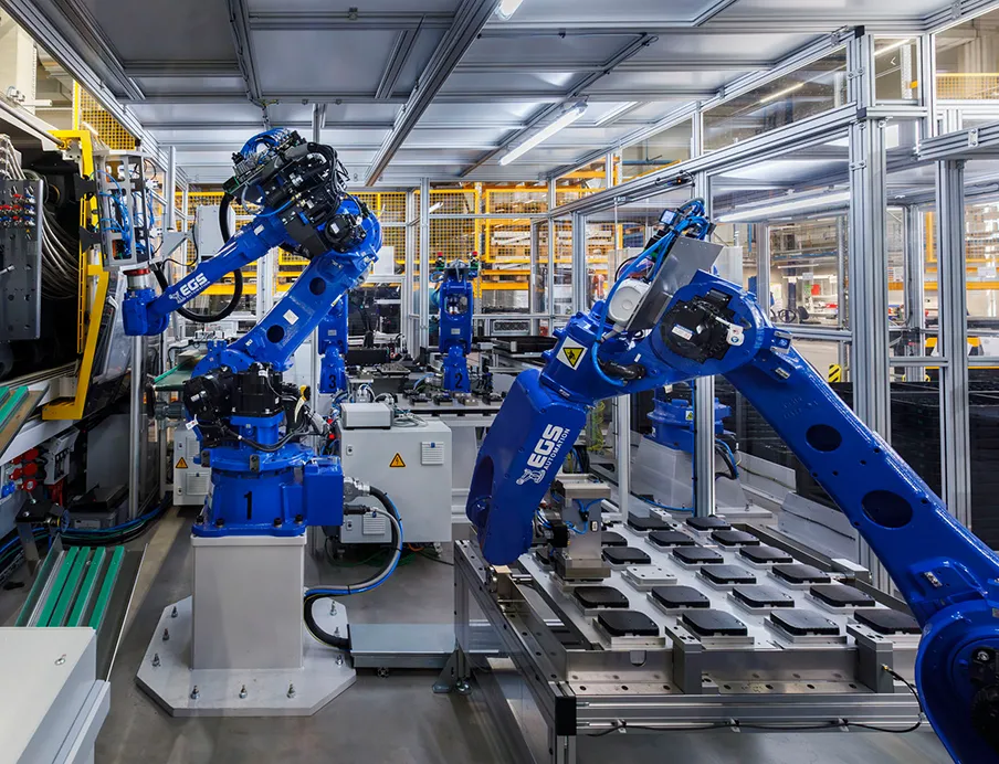 Automatisierung in der 2K-Spritzgießzelle: Während ein „Yaskawa GP25“ die Zwischenablage vor der Spritzgießmaschine bestückt, übernimmt der größere „GP50“ deren Be- und Entladung